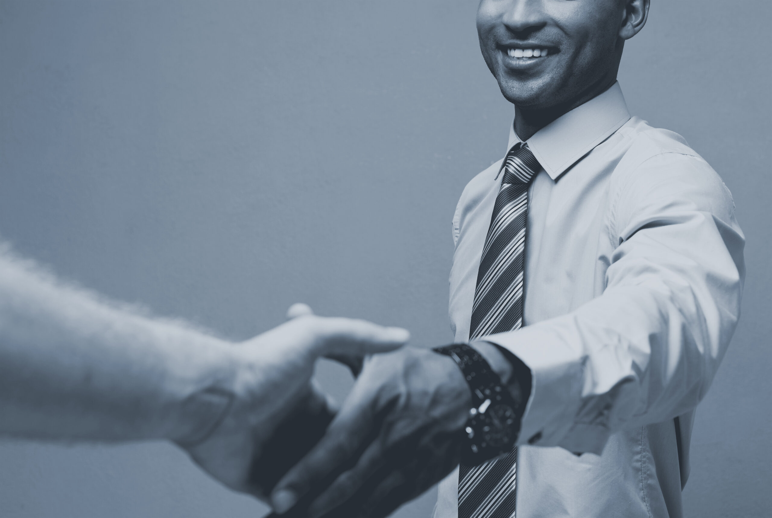 Close-up of two confident business people shaking hands during a meeting.